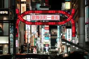 Explore the lively and illuminated streets of Kabukicho in Shinjuku, Tokyo, capturing the essence of urban nightlife.