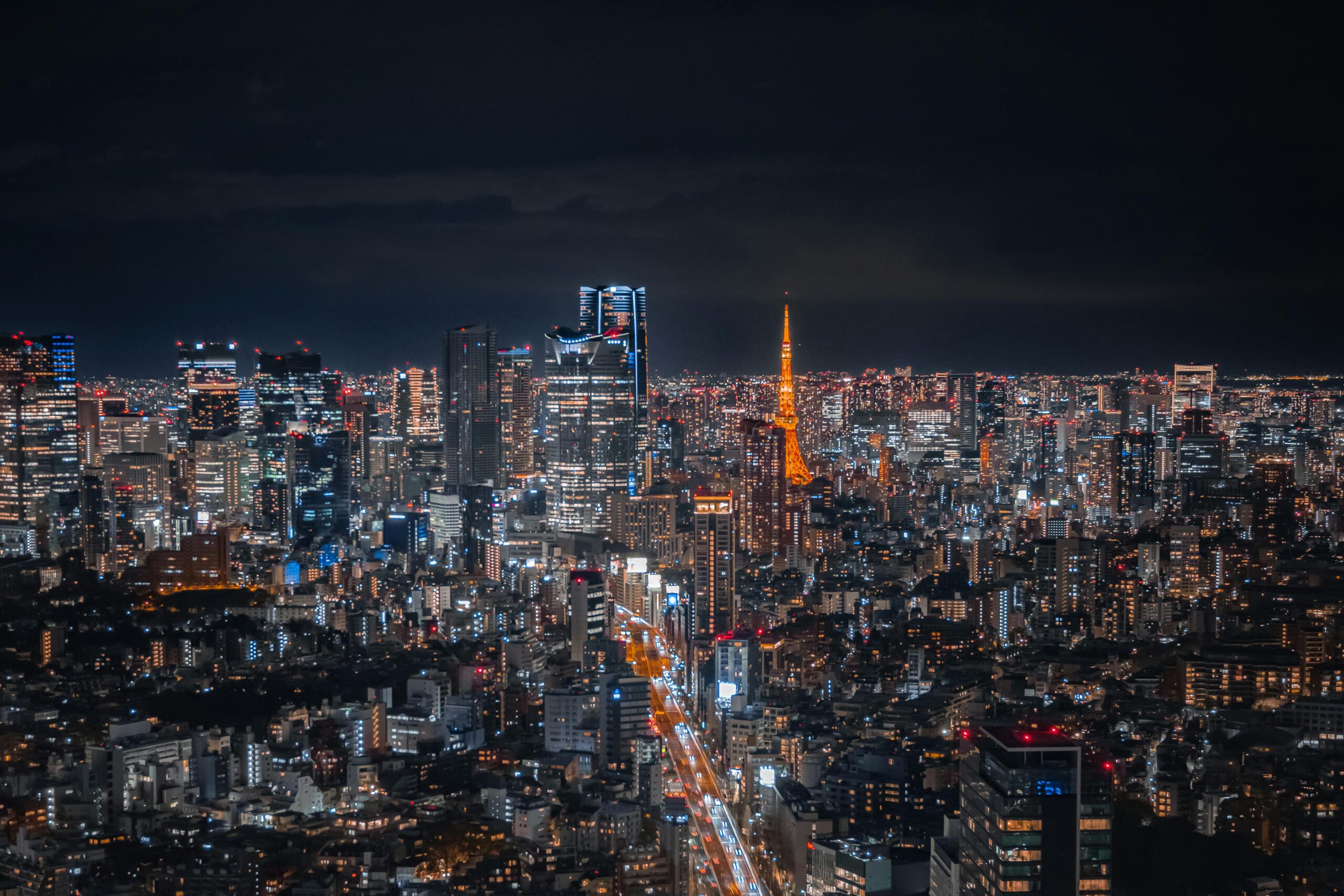 A breathtaking view of Tokyo's skyline at night featuring the illuminated Tokyo Tower.