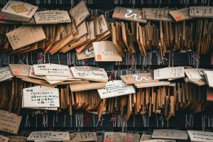 Traditional ema prayer plaques at a shrine in Kawagoe, Japan, conveying various wishes and prayers.
